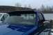 1993 Ford F-150 - A blue pickup truck is parked next to a white truck, with a visor installed above the windshield.