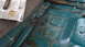 1992 Ford Bronco - The floor pan of a vehicle shows significant rust and exposed wiring, indicating wear and tear.