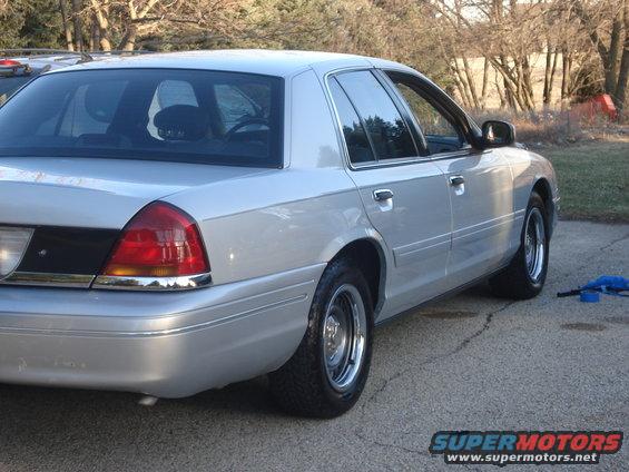 Silver 2000 Ford Crown Victoria parked on asphalt, rear quarter view