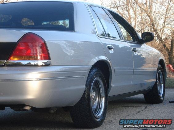 Silver 2000 Ford Crown Victoria, rear quarter view showing taillight and chrome trim
