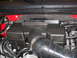 2011 Ford F-150 - Engine intake manifold with 6.2L badge and air intake hose.
