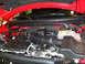 2011 Ford F-150 - The engine bay of a red 2011 Ford F-150 Raptor, with the hood open, revealing the engine components.