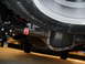 2011 Ford F-150 - Underside view of a vehicle's rear axle and tire, showing the differential and a red sticker on the axle.