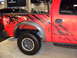 2011 Ford F-150 - This red pickup truck features aggressive black graphics that resemble claw marks on its body panels.