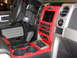 2011 Ford F-150 - The interior of a 2011 Ford F-150 features a striking red trim accenting the center console and dashboard.