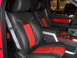 2011 Ford F-150 - The interior of a truck features black leather seats with red accents and a gray seatbelt.