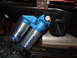 2011 Ford F-150 - Close-up of a blue SVT bypass shock absorber, part of the suspension system, the Fox logo and 'NG SHOX' text.