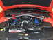 2012 Ford Mustang - The engine bay of an orange Ford Mustang shows its V8 engine with blue accents.