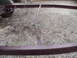 1993 Tracker Tournament - Close-up of a trailer frame, showing its construction and a single wheel.