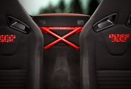 Black car seats with red "BOSS 302" embroidery and a red "MUSTANG" brace