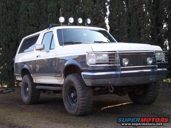 1989 Ford Bronco, two-tone paint, off-road tires, light bar on roof