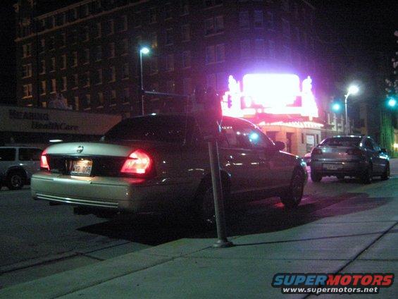 2000 Mercury Grand Marquis parked on street at night, another car behind it