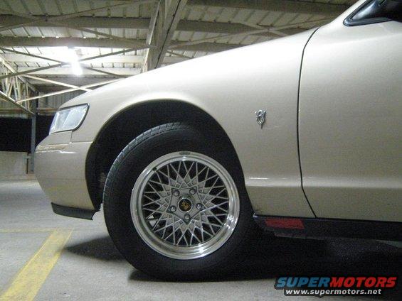 Tan 2000 Mercury Grand Marquis 3q-front view showing fender badge and mesh wheels