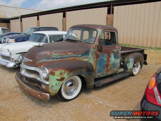 Rusty vintage pickup truck with whitewall tires, 3q-front view