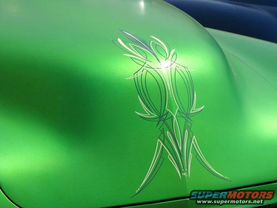 Green car hood with pinstripe graphics, close-up view