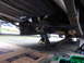 1964 Ford Fairlane - Vehicle's rear axle and suspension components are visible while supported by jack stands.