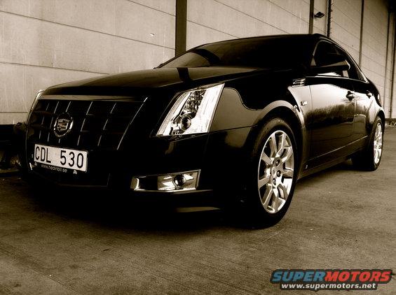 Black Cadillac sedan with license plate CDL 530 parked indoors