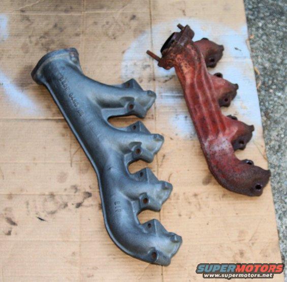 Two cast iron exhaust manifolds, one painted gray, the other rusted red, on a cardboard surface