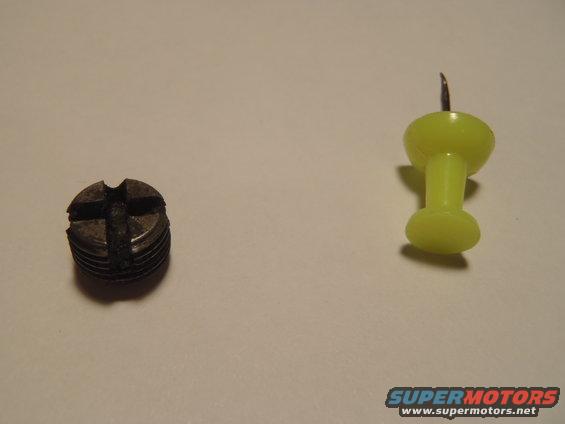 Screw next to a yellow thumbtack