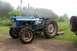 2000 Chevrolet Tahoe - Side view of a blue tractor with large rear tires and a tall exhaust pipe.