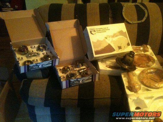 Several boxes containing differential bearings and gears, with one box showing a polar bear graphic