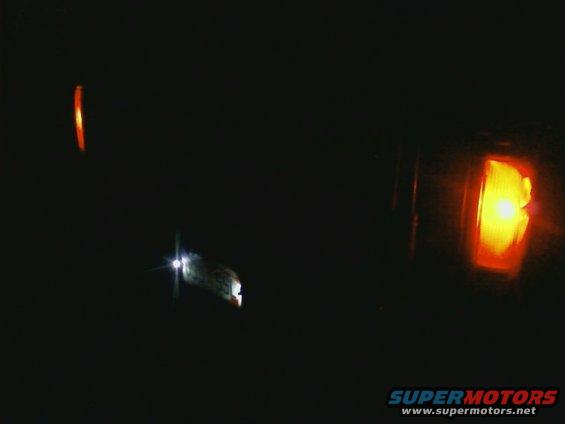 Headlight and amber marker light illuminated in darkness