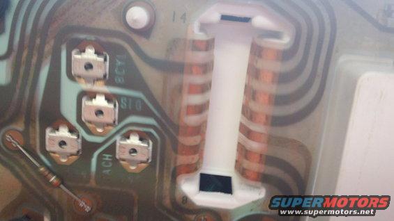 Close-up of an instrument cluster circuit board with copper traces and connectors