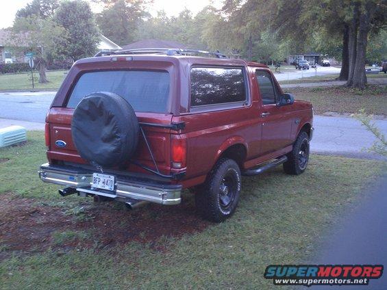 Red 1996 Ford Bronco rear view with spare tire on tailgate