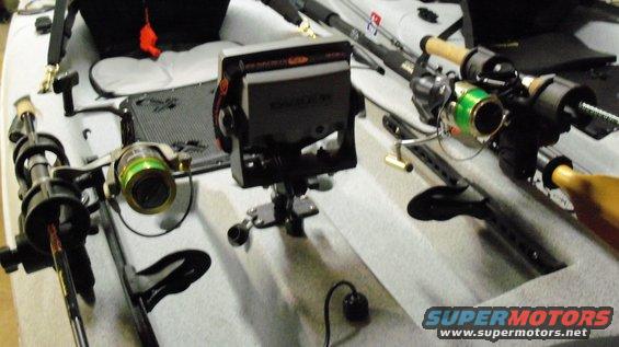 Fishing kayak interior with two fishing rods, reels, and a fish finder mounted