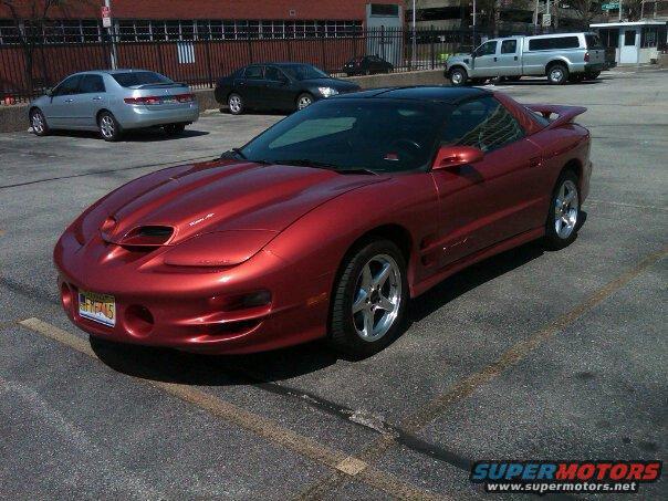 Red 2001 Pontiac Trans Am with a black roof and spoiler