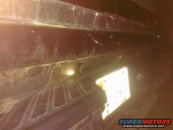 Rear bumper with license plate and taillight housing