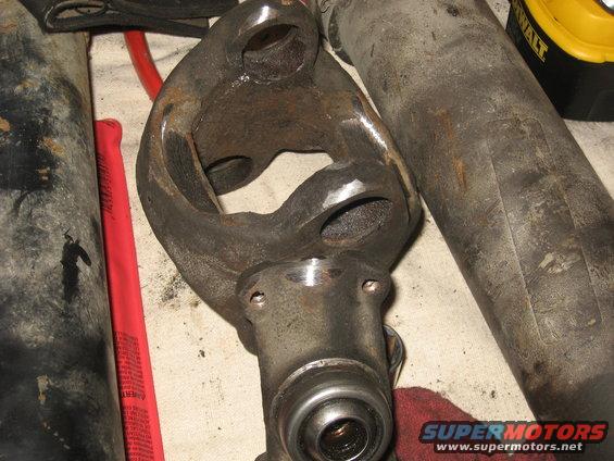 Close-up of a driveshaft universal joint with surrounding metal parts