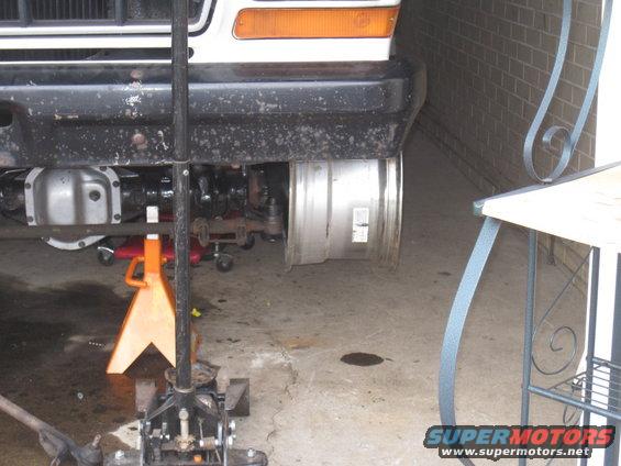 1979 Ford Bronco front suspension on jack stands, showing differential and wheel