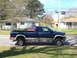 2005 Dodge 2500 - Side view of a blue 2005 Dodge 2500 pickup truck with chrome wheels.