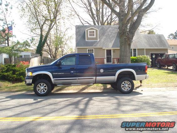 Blue Dodge Ram 2500 pickup truck, two-tone paint, chrome wheels, parked on street