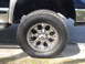 2005 Dodge 2500 - Close-up of a 2005 Dodge 2500's aftermarket chrome wheel and all-terrain tire.