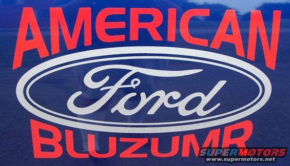 Close-up of a blue surface with a Ford oval logo and red text reading 'AMERICAN BLUZUMR'