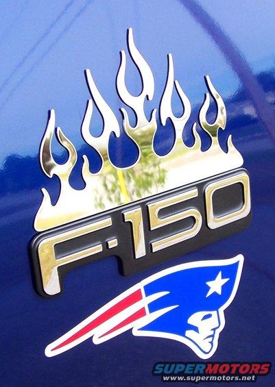 Blue vehicle panel with chrome F-150 emblem and flame graphics, plus a Patriots sticker
