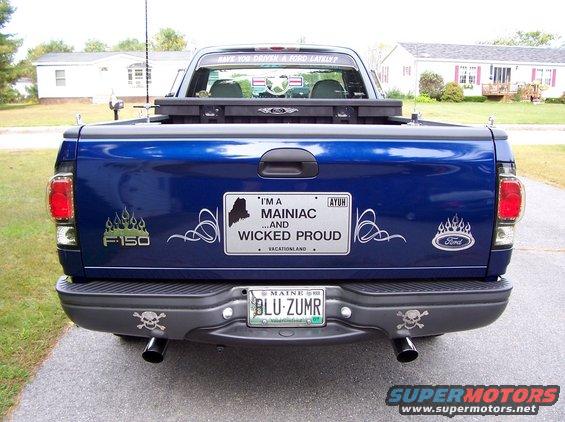 Rear of dark blue Ford F-150 with 'I'm a Mainiac' tailgate graphic and Maine plate BLU ZUMR