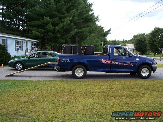 Pine needle removal using a ramp and containers on wheels.