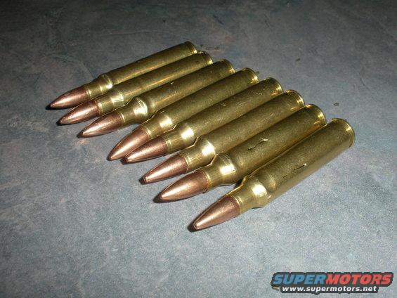 Several brass cartridges with copper-tipped projectiles arranged in a row