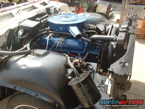 1967 Ford Galaxie engine bay with blue V8 engine and air cleaner