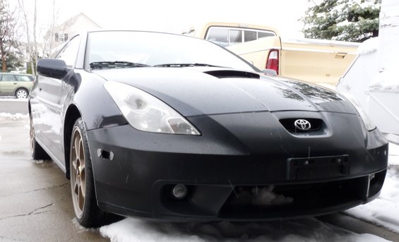 Black Toyota Celica front view in snow