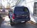 2004 Nissan Xterra - Rear view of a blue 2004 Nissan Xterra SUV parked on a driveway.