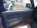 2004 Nissan Xterra - View of the interior door panel and a dark SUV parked outside the blue vehicle.