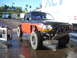 1992 Ford Ranger - This modified pickup truck features off-road tires and a custom bumper, suggesting it's built for terrain.