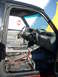 1992 Ford Ranger - Interior view of a truck, showing a damaged driver's seat and hazardous material warnings on the windshield.