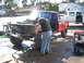 1992 Ford Ranger - A person is working on the engine bay of a red pickup truck that has had its front end removed.