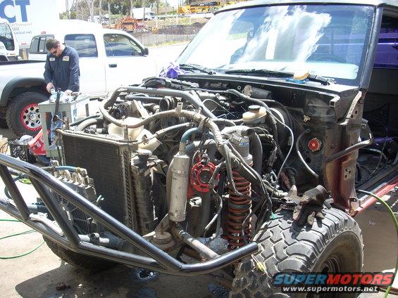1992 Ford Ranger engine bay with custom roll cage, front suspension, and radiator exposed