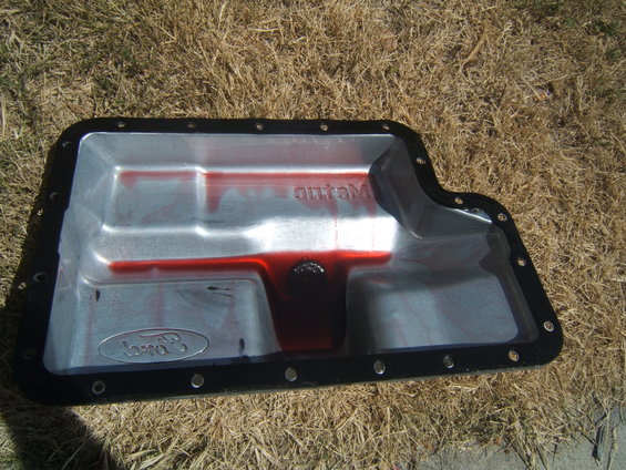 Ford transmission pan with red fluid and metal shavings